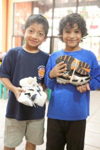 The God's Child Project - Two boys Holding on to Athletic Shoes